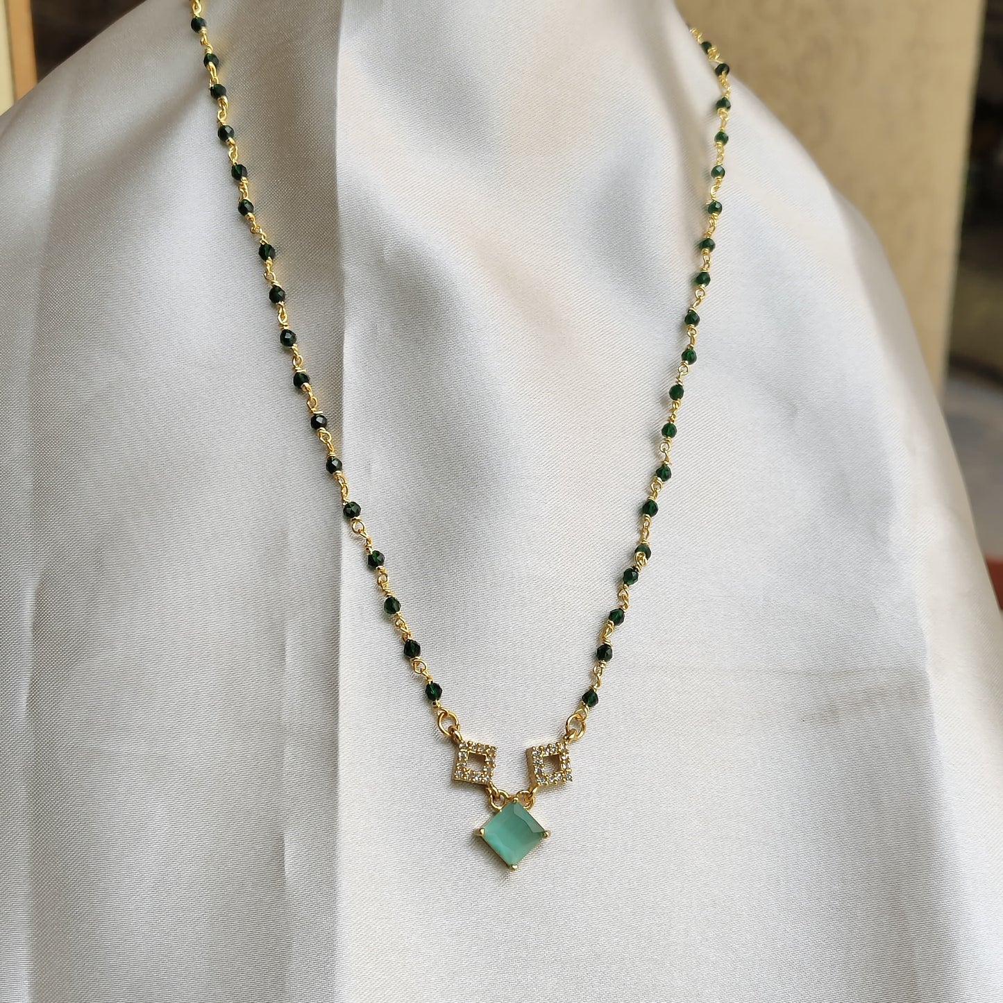 Elegant Gold-Plated Necklace with Green Stone and Crystal Accents