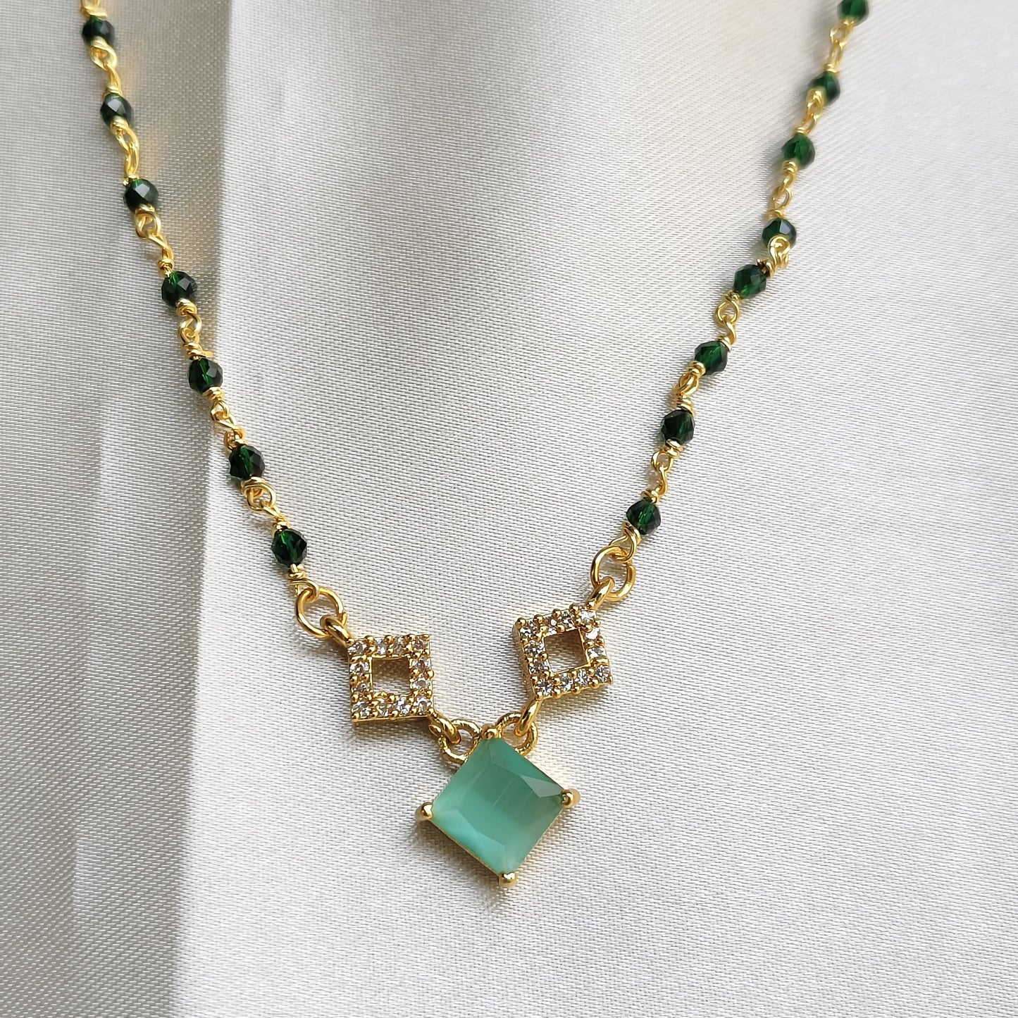 Elegant Gold-Plated Necklace with Green Stone and Crystal Accents